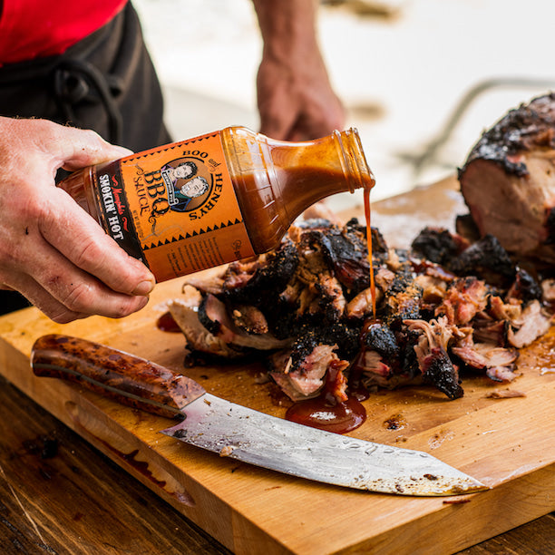 Boo and Henry's Smokin' Hot BBQ Sauce poured over burnt ends